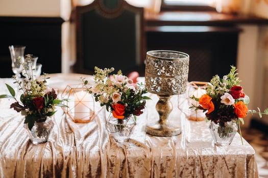 wedding table decoration with flowers on the table in the castle, table decor for dinner by candlelight.Dinner with candles photo