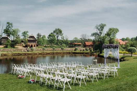 Decoration of the wedding ceremony in summer near the lake on the green grass.beautifully decorated wedding ceremony photo