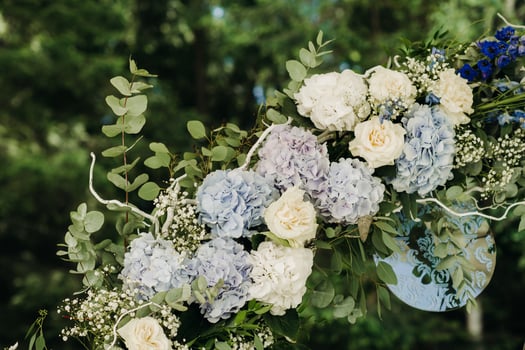 Wedding ceremony on the street on the green lawn.Decor with fresh flowers arches for the ceremony photo