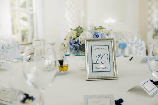 wedding table decoration with blue flowers on the table in the restaurant table decor for dinner at the wedding. photo