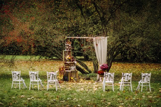 Autumn wedding ceremony on the street on the green lawn.Decor with arches of fresh flowers for the ceremony photo