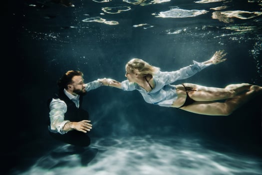 A woman and a man meet under water.A couple of lovers under water photo