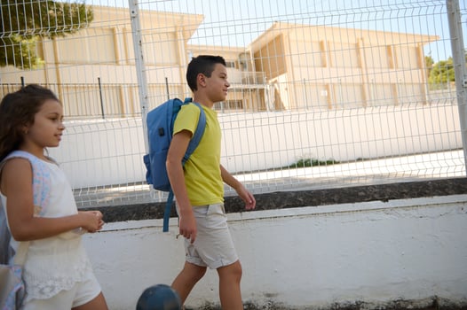 Children walking to school together on a sunny day photo