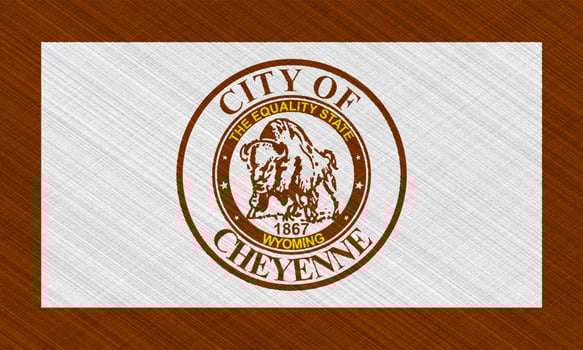 Flag of the city of Cheyenne, Wyoming, USA, on a background of fabric texture. Conceptual collage photo