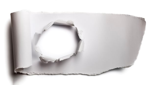 a white paper hole torn photo