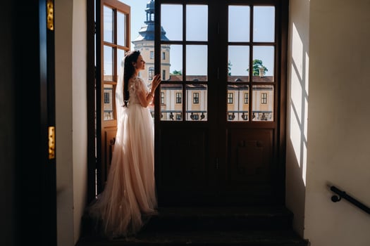 An elegant bride on the balcony of an ancient castle in the city of Nesvizh photo