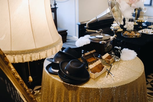An old retro gramophone, hats and cigars are on the table photo