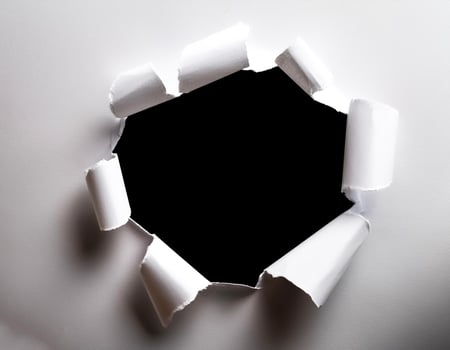 a white paper hole torn photo