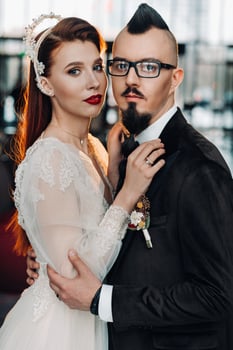 Stylish wedding couple in the interior. Glamorous bride and groom photo
