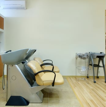 Chair for washing hair in a Barber shop. Interior of a Barber shop. A cruel place. Chair in beige leather in a beauty salon. photo