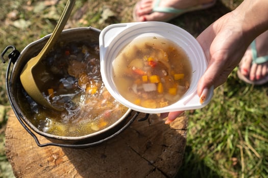 ready mushroom soup cooked over a fire is poured into a plate photo