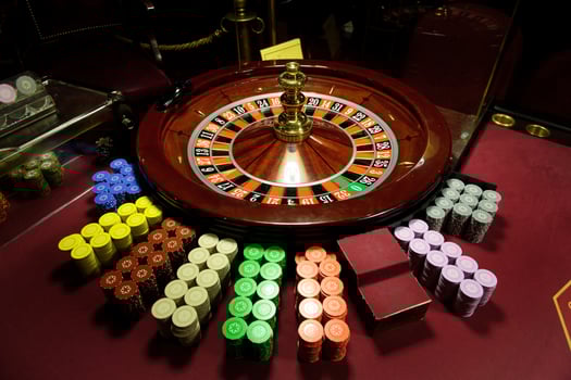 close-up chips and roulette at the casino on the red table photo