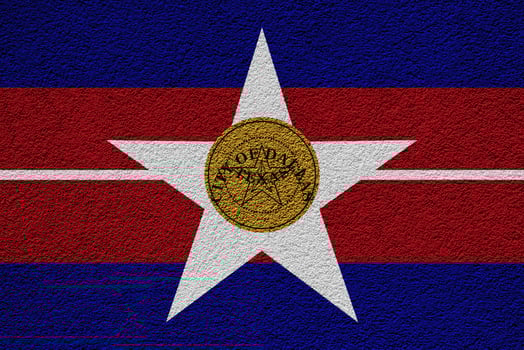 Flag of the city of Dallas, Texas, USA, on a background of a plaster wall. Conceptual collage photo