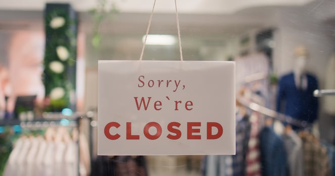 Extreme close up shot of close sign in luxurious clothing store with elegant assortment of shirts. Sorry we are closed message on premium fashion boutique door with trendy stylish attire garments photo