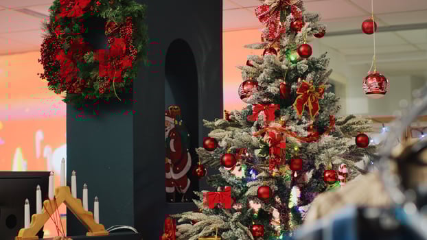 Beautifully decorated Christmas tree and decorations in festive clothing store inside mall. Xmas adorn fashion attire shop waiting for customers during winter holiday season photo
