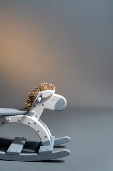 Handmade rocking horse on a gray background photo