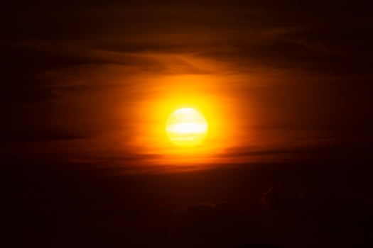 Big sun on Sunset sky with dark clouds. photo