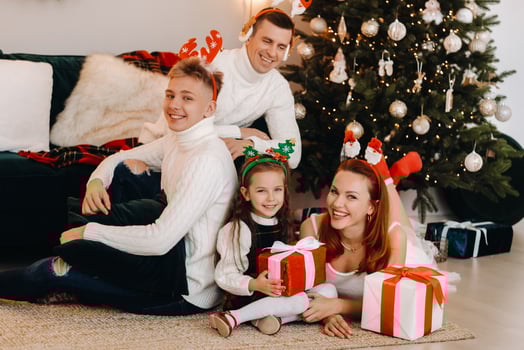 Happy family near the Christmas tree with gifts photo