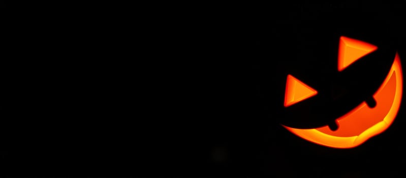 Glowing Jack-o'-Lantern Smile in Darkness photo