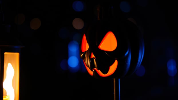 Glowing Halloween Pumpkin with Lantern in the Dark photo