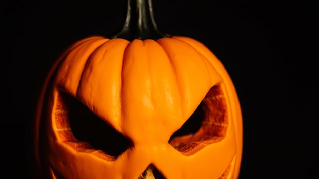 Closeup of a Carved Pumpkin with Glowing Eyes photo