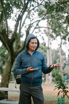 Southeast Asian man showing something in his hand, offering a sense of curiosity or presentation photo