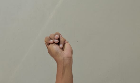 Finger spelling letter M in american sign language photo