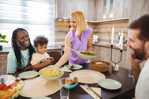 Family at a bright dinner table in daylight photo