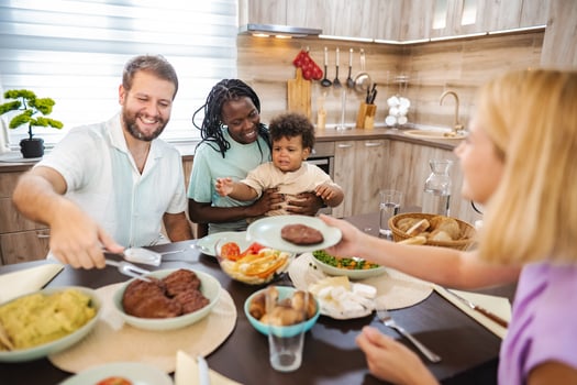 Family gathers at the kitchen table for dinner photo