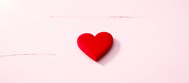 Red Heart on Pink Background photo