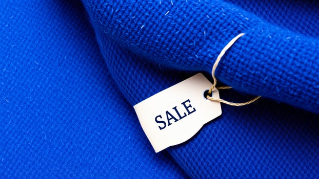 Sale Tag on Blue Fabric photo