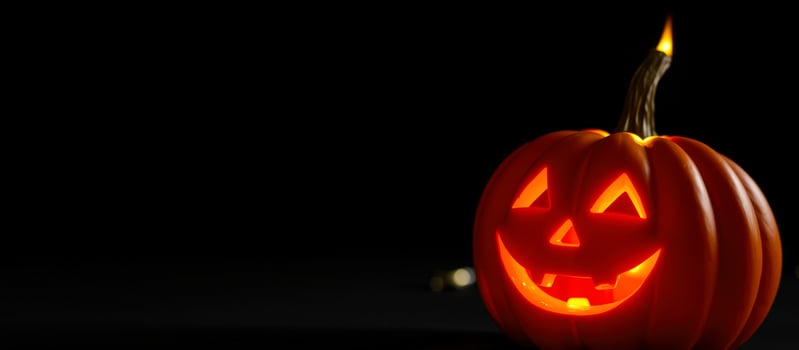 Lit Jack-O-Lantern on Black Background photo