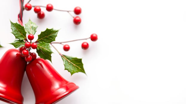 Red Christmas Bells with Holly and Berries on White Background photo