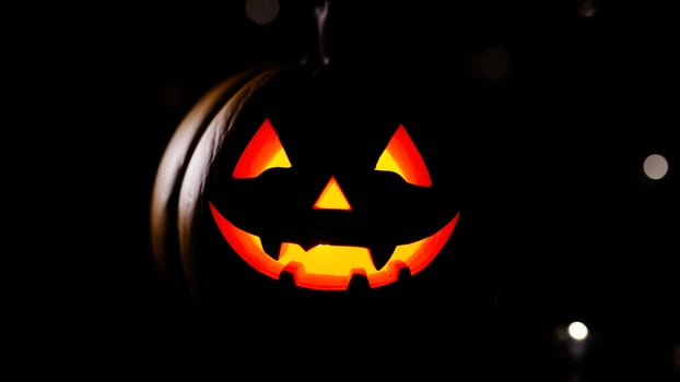 Spooky Jack-o'-Lantern Glowing In The Dark photo