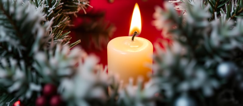 Burning candle in a Christmas wreath photo