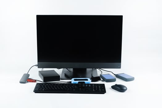 Multiple external hard drives connected to a monoblock on a white background.Computer with hard drive photo