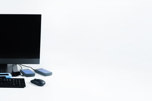 Multiple external hard drives connected to a monoblock on a white background.Computer with hard drive photo