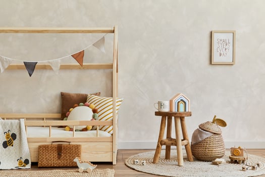 Stylish composition of cozy scandinavian child's room interior with wooden bed, toys and hanging decorations. Creative wall. Copy space. Template. photo