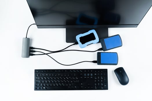 Multiple external hard drives connected to a monoblock on a white background.Computer with hard drive photo