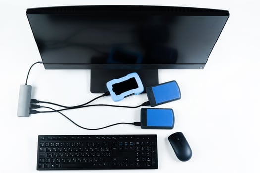 Multiple external hard drives connected to a monoblock on a white background.Computer with hard drive photo