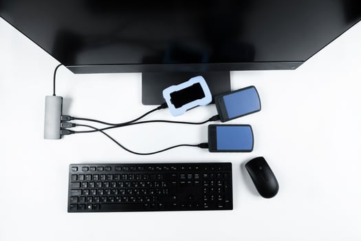 Multiple external hard drives connected to a monoblock on a white background.Computer with hard drive photo