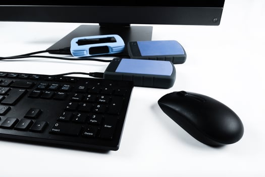 Multiple external hard drives connected to a monoblock on a white background.Computer with hard drive photo