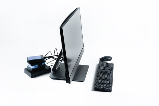 Multiple external hard drives connected to a monoblock on a white background.Computer with hard drive photo