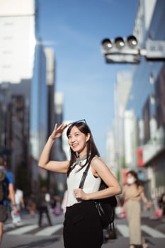Youthful confidence, Cool and cheerful Japanese woman in her 30s, showcasing a perfect blend of style, confidence, and modern technology. photo