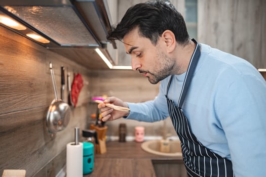 Man Standing in Kitchen Preparing Food photo