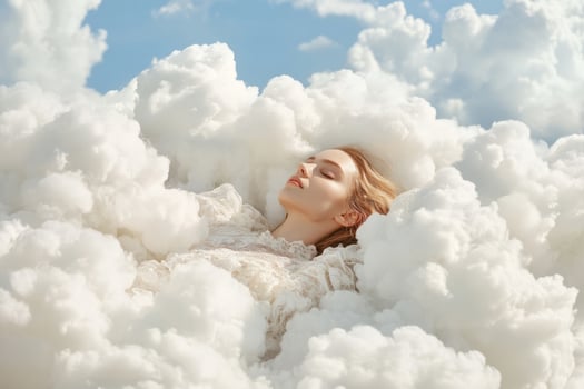 Woman lies among fluffy white clouds. Calm dreamy emotions photo