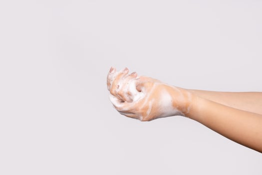 Young Asian woman washing hands isolated on white background. Hygiene and cleanliness concept. photo