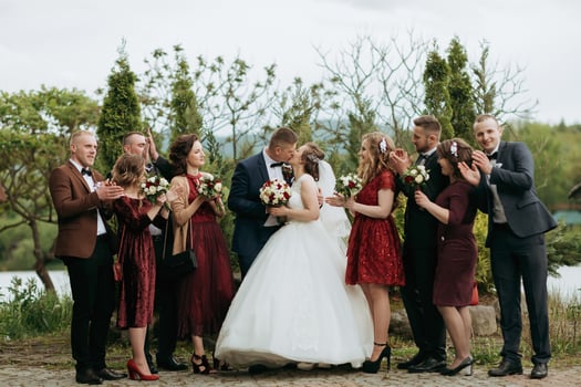 A group of people are posing for a picture, with a bride and groom in the center photo