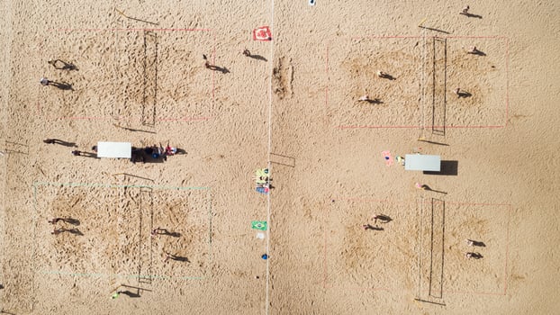 Top view of a group of friends playing beach volleyball on the beach photo