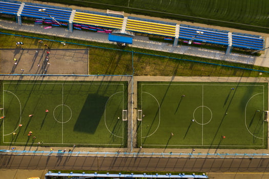 Top view of a sports football field with players playing football.a small football field on the street in the city.Belarus photo